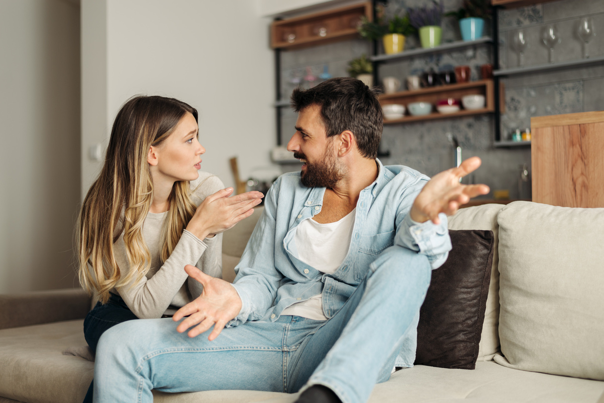 Angry couple arguing in the living room